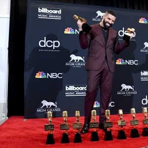 Drake poses with the awards